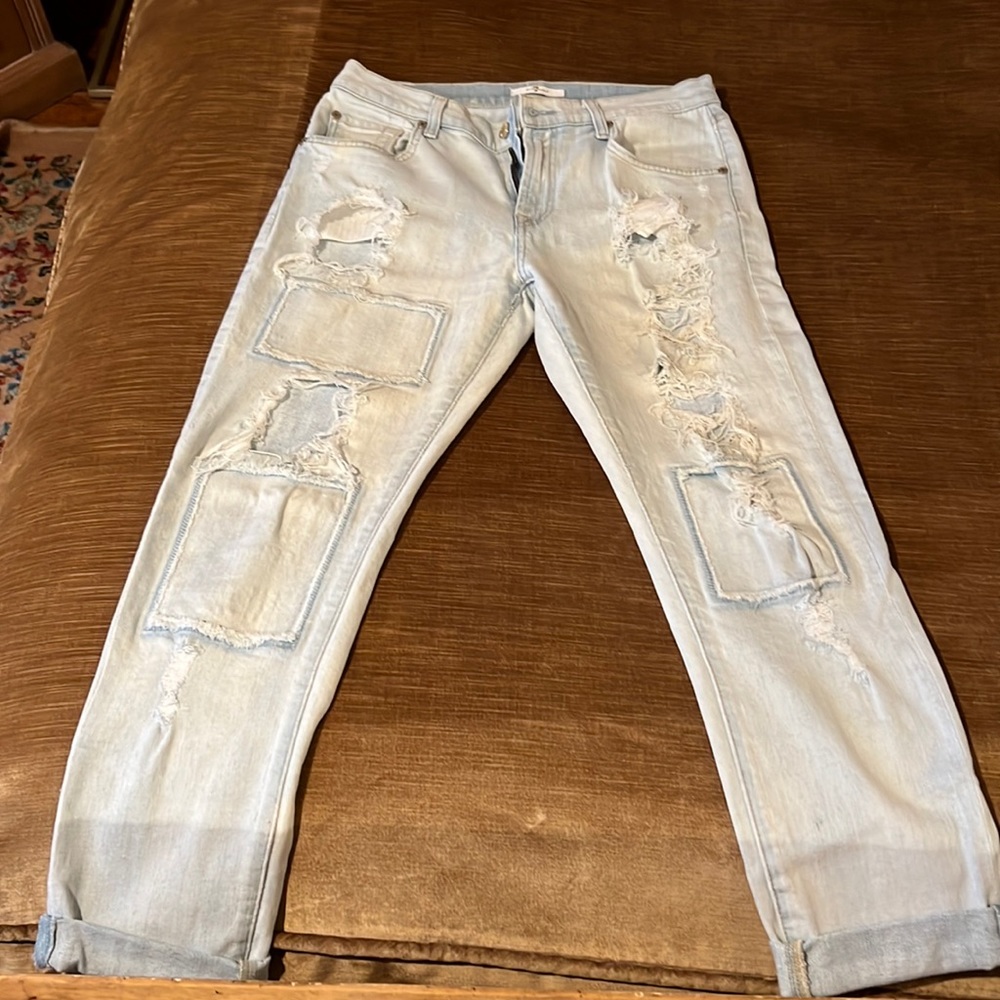 Woman’s jeans size 27 white washed distressed with patches and frayed spots